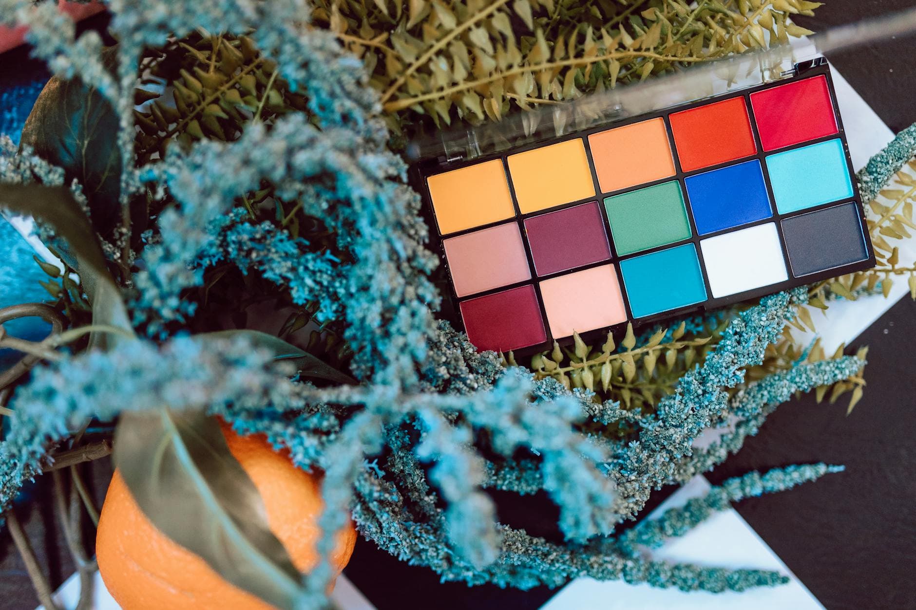 Ultimate Makeup Palette with vibrant colors on a floral background